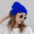Model wearing a vivid klein blue cuffed beanie hat showing vibrant streetwear styling.