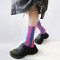 Model wearing a pair of pink Contrast Color Striped Socks, great for casual wear and light workouts.