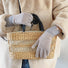 Flat lay contrast striped knit gloves with ribbed cuffs; cozy accessory for winter commuting.