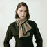 Model wearing a Beige wool-polyester knit scarf with black contrast trim in gray and khaki, ideal for daily wear.