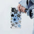 Clear silicone iPhone case with various black, silver, and blue stars. Transparent youthful design accessory.
