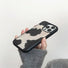 Close-up of Model holding Cow Print Leather Case. Bold high-contrast motif on resilient silicone body.