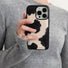 Model holding Cow Print Leather Case. Premium faux-leather finish perfect for streetwear and daily outfits.