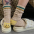 Styling cheerful khaki smiley socks for a cozy home aesthetic, perfect for personal comfort or gifting.