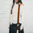 Model wearing a wool scarf in beige and brown, great for office layering and commuting.