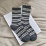 Front view of Cozy Wool Striped Socks in gray, easy to pack for travel and errands.