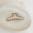 Folded view of Cream Black Border Hair Claw in moon shape, ideal for quick updos and ponytails.