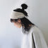 Model wearing a  Crochect Bow Headband in white, ideal for everyday outfits and office looks.