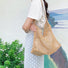 Model carrying a camel Crochet Shoulder Bag With Leather Strap, easy for commuting.