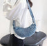 Model carrying a washed blue Croissant Denim Shoulder Bag on the shoulder, easy for commuting and weekends.