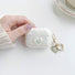 Model Hands holding a Crystal Shell AirPods Case Cover, ideal for gifting and everyday carry.