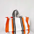 Front view of the designer canvas tote bag with bold orange and black stripes.