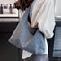 Model carrying a dark blue Diamond pattern Denim Shoulder Bag on the shoulder, ideal for city walks and gifting.