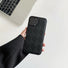 Model holding black Diamond Pattern Leather Case. Elegant embossed diamond-quilt for Old Money style.