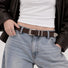 Close-up of a model wearing the brown double keeper belt with denim jeans and a dark brown jacket for a retro casual look.