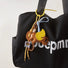 Dumbo Bag Charm hanging on a black tote bag, easy for gifting and photo-ready styling.