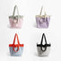Four duotone foldable nylon tote bags in pink/sage, lavender/cream, blue/orange, and black/grey.