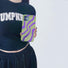 Model holding Electronic Vortex Case. Showcasing futuristic neon pattern for edgy modern street fashion.