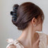 Model wearing Elegant Wave Hair Claw  in black, great for everyday styling and gifting.
