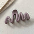 Angled view of Elegant Wave Hair Claw  in purple, great for everyday styling and gifting.