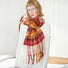 Fiery Sunrise Plaid Scarf: Wool blend, 82"x 14.6", with red, orange, and yellow plaid pattern and fringe.