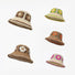 Five crocheted straw floral bucket hats in brown, yellow, orange, white, and pink for summer leisure.
