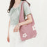 Pink blended knitting yarn crochet shoulder bag with white flower details.