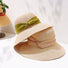 Foldable straw sun hats with wide brims and elegant ribbon bands in olive green and classic beige.