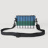 Flat lay of the FREEIN Spectrum bag showing the outer zip pocket and vibrant blue-green striped pattern.