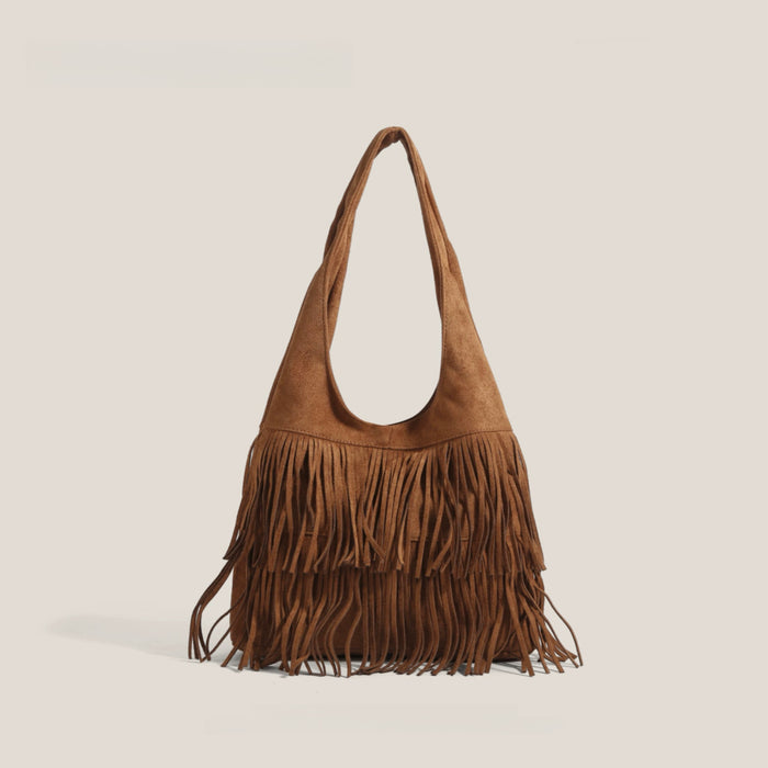 Tan vegan suede hobo bag with bohemian fringe detailing and a soft slouchy silhouette.