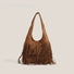 Tan vegan suede hobo bag with bohemian fringe detailing and a soft slouchy silhouette.