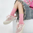 Model wearing a pair of  Fuzzy Embossed Socks in pink, easy to pack for travel and errands.