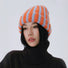 Model wearing a vibrant orange and blue fuzzy contrast striped beanie.