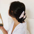 Model wearing Gentle Curve Hair Claw in rose shell, easy for workdays and special occasions.