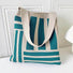 Folded view of Geometric Line Knitted Bag in viridian, easy for commuting and weekends.