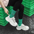 Close-up of model wearing Googly Eyes Socks in green, easy to pack for travel and errands.