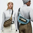Two models wearing earth brown and light blue nylon sling bags, demonstrating a modern Gorpcore urban aesthetic.