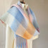 Model wearing the gradient plaid scarf as a full wrap-around shawl, easy for weekend.