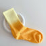 Front view of Gradient Rainbow Socks in orange and yellow, easy to pack for travel and errands.