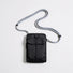 Front flat lay view of the classic black grid magnetic utility crossbody bag with adjustable rope strap.