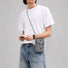 Male model wearing the grey grid magnetic utility bag across the chest for everyday carry.