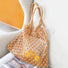Tan hollow crochet tote bag made from cotton rope, 11.4"x10.6", with braided handles.