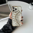 Model holding Hollow Fishbone Phone Case in polish gold. Artistic metallic finish for a luxury fashion look.