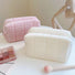Folded view of Icecream Makeup Bag in white and pink, great for on-the-go touch-ups.