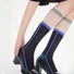 Model wearing a pair of Juicy Patchwork Knee-high Socks in black, easy to pack for travel and errands.