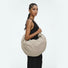 Model carrying the khaki duvet crescent bag, perfect for a modern minimalist look.
