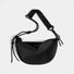 Front view of black knotted nylon crescent sling bag, highlighting the high-density ripstop material and zip-top.