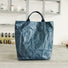 Front view of a blue Kraft-like edgy tote bag with a unique crinkled paper texture, showcasing a minimalist industrial design.