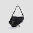 Angled view of Black PU leather saddle bag with braided top handle, removable shoulder strap, and decorative.