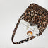 Polyester leopard print leisure tote bag with inner pockets, holding a phone, perfume, and cosmetics.
